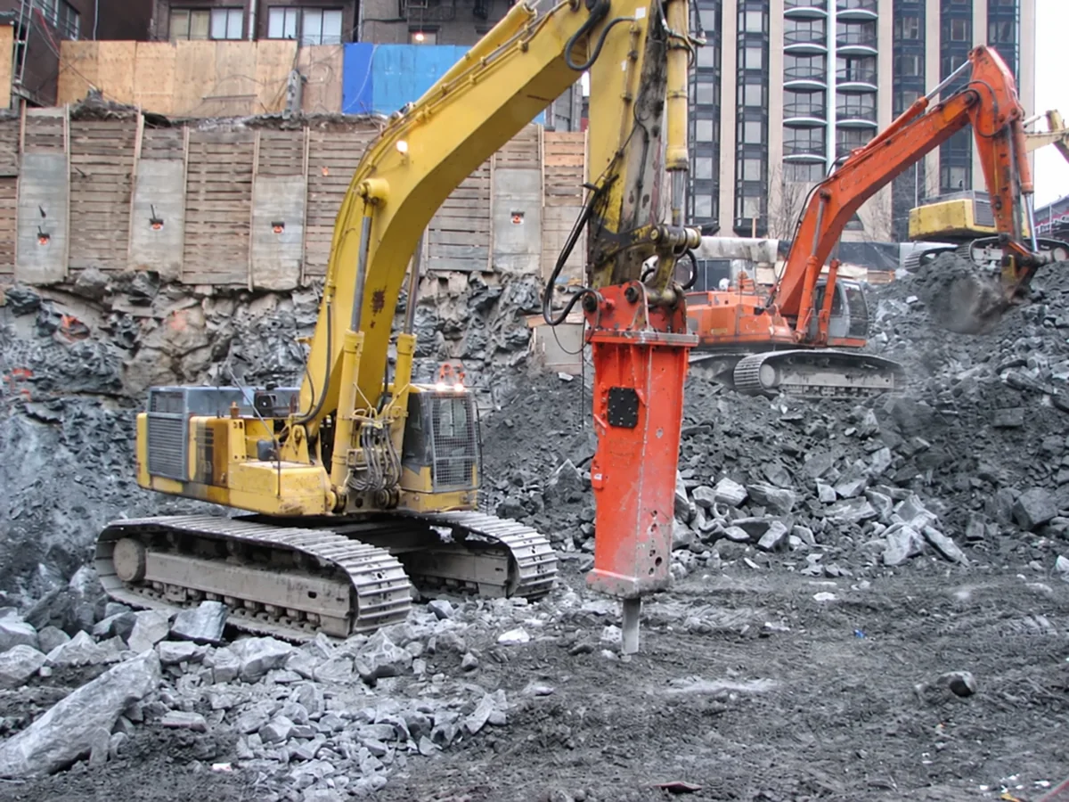 Excavator-mounted breaker at a construction site