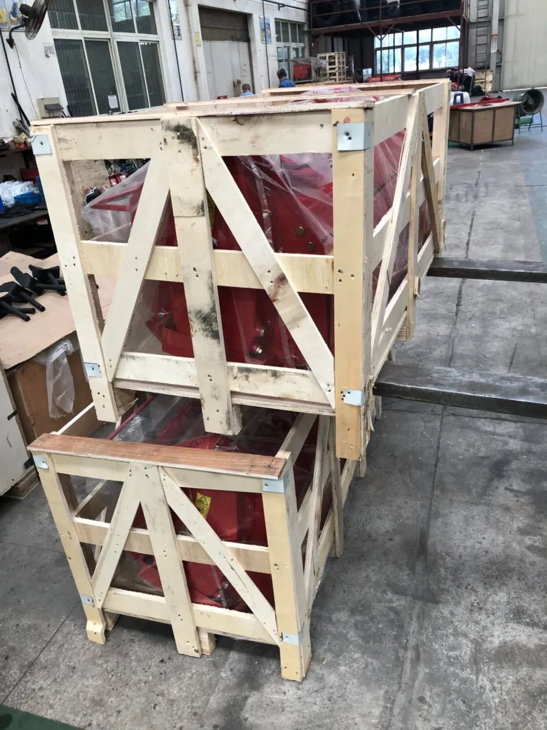 Rotary tillers secured inside reinforced wooden transport crates