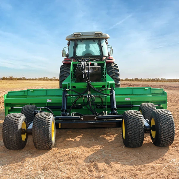 Tractor towing a satellite land leveller across an agricultural field