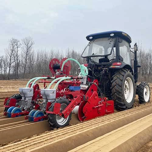 Tractor-mounted four-row pneumatic vegetable seeder operating on crop beds
