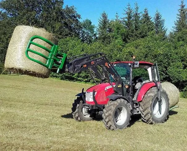 Round-bale handling with a loader-mounted bale grab