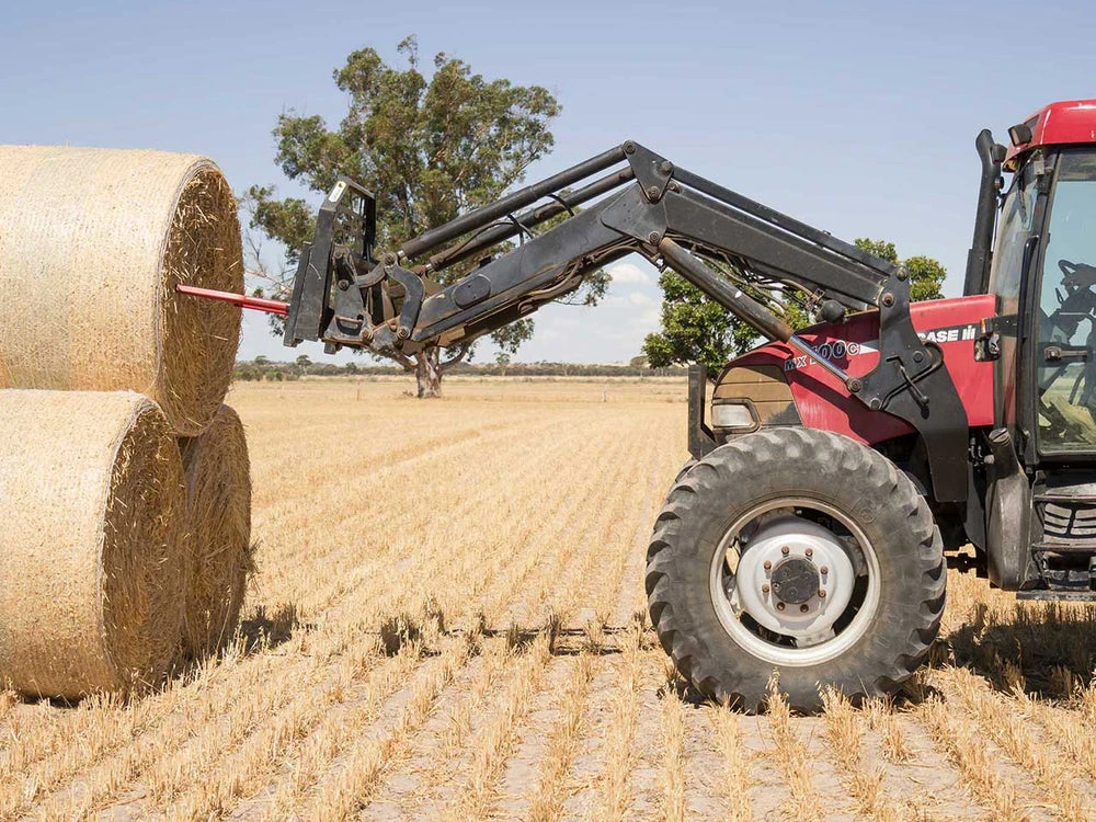 Bale handling with a loader-mounted bale spear