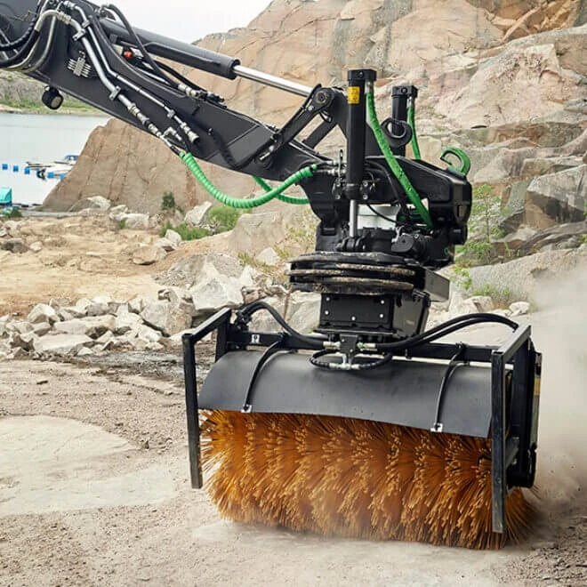 Surface cleaning with an excavator-mounted rotary broom