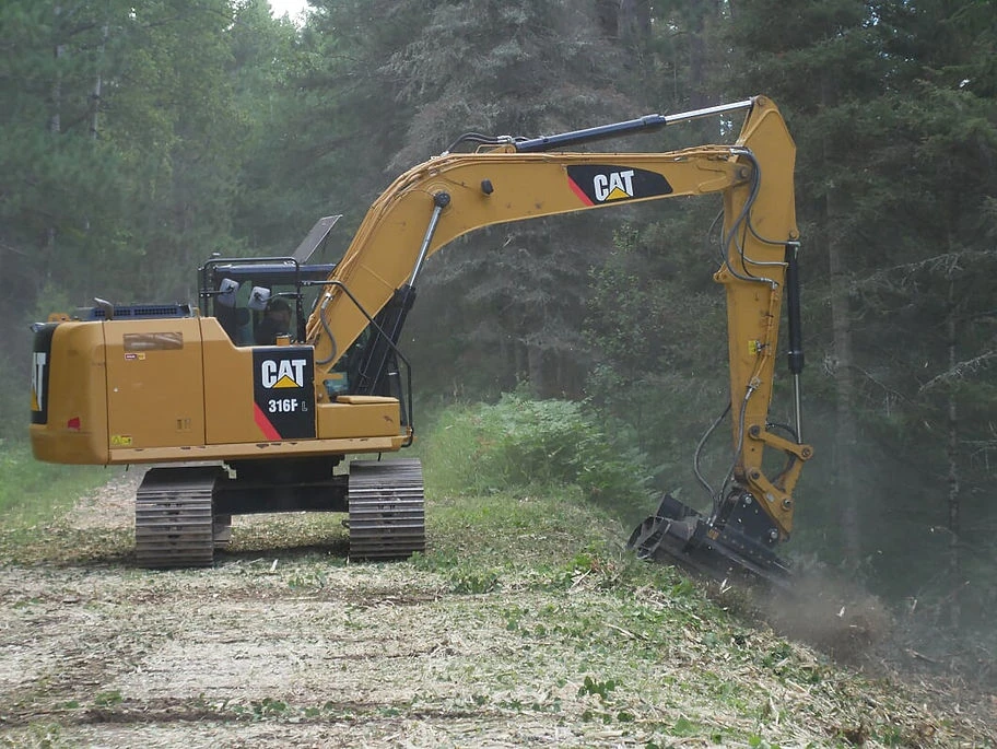 Vegetation clearing with an excavator-mounted forestry mulcher