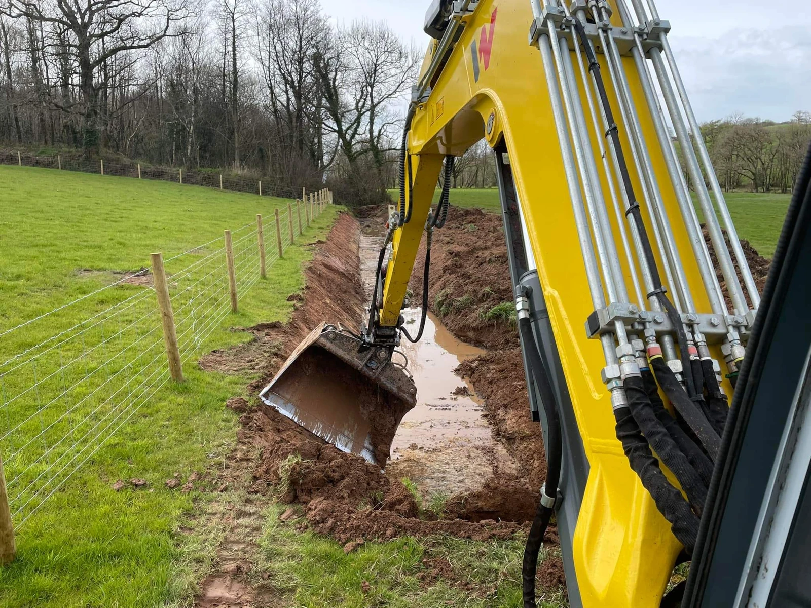 Ditch grading with a wide grading bucket