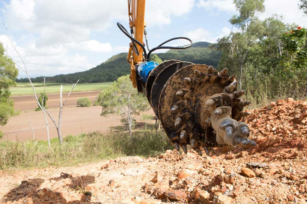 Rock auger with carbide cutting teeth at a drilling site