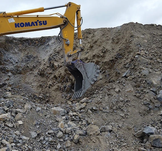 Rock excavation with a reinforced rock bucket