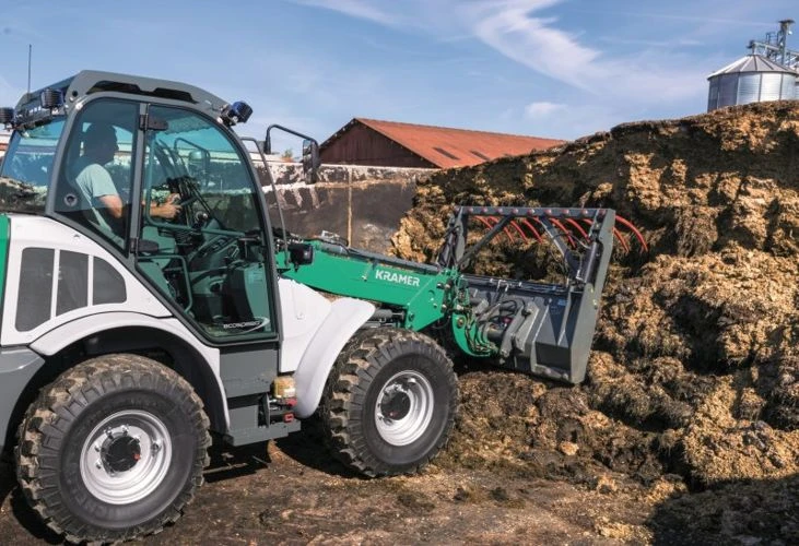 Silage handling with a loader-mounted fork and grapple