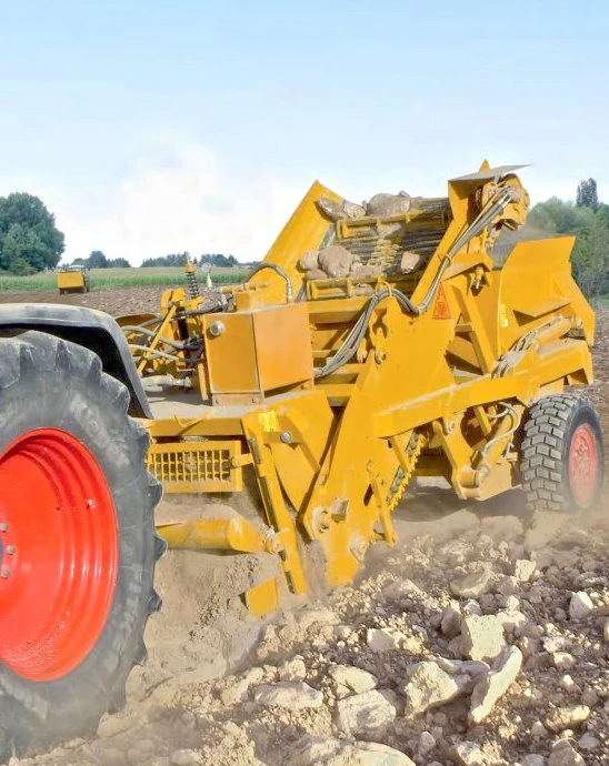 Field-stone collection with a tractor-towed stone picker
