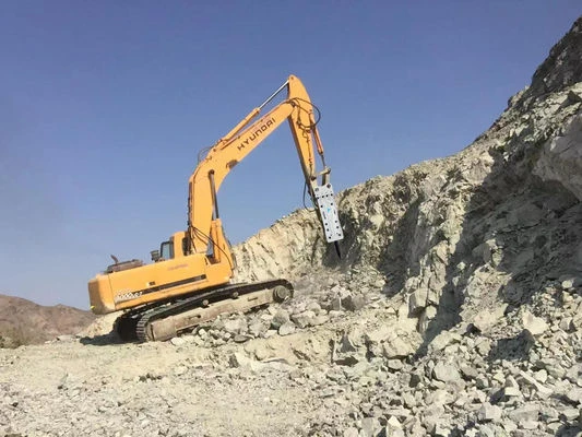 Rock breaking with a top-mounted hydraulic breaker